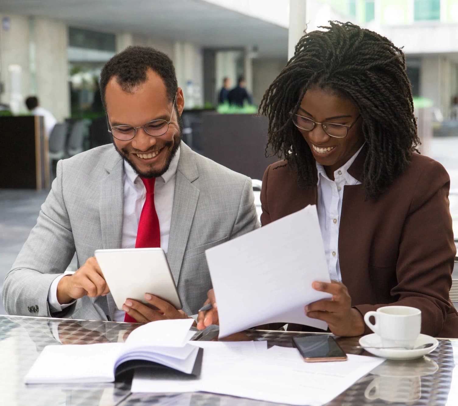 Finsbridge Limited About Us Image-Colleagues discussing financial reports while smiling