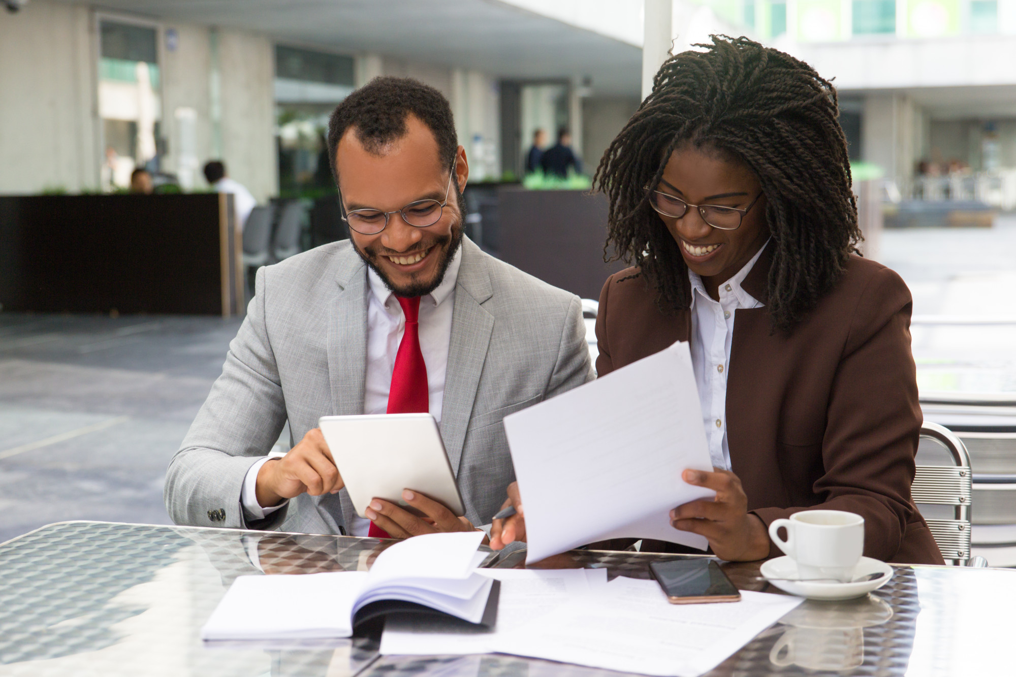 Finsbridge Limited About Us Image-Colleagues discussing financial reports while smiling